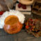 This shows Wallace the pumpkin with his hat off and sitting next to him. It shows his wispy hair that is attached to the rim of the gourd.